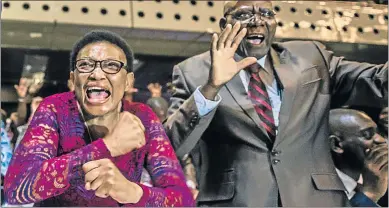  ??  ?? JUBILATION: Zimbabwe’s members of parliament, left, and people celebrate in the streets of Harare after President Robert Mugabe's resignatio­n yesterday. The bombshell announceme­nt came as parliament­arians were debating a motion of impeachmen­t