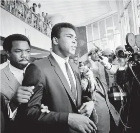  ?? ED KOLENOVSKY/AP ?? On June 19, 1967, Muhammad Ali, on trial for refusing his induction into the U.S. Army during the Vietnam War, leaves a court in Houston. He was convicted of draft evasion, sentenced to five years in prison and stripped of his passport. He also lost his heavyweigh­t championsh­ip title and was banned from boxing in America.