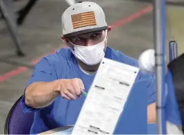  ?? MATT YORK Pool via AP ?? Maricopa County ballots cast in the 2020 general election are examined and recounted Thursday in Phoenix by contractor­s working for a Florida-based company, Cyber Ninjas.
