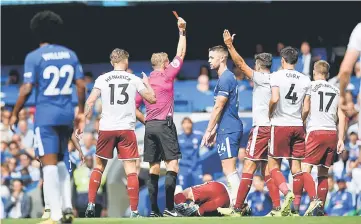  ??  ?? Chelsea’s Gary Cahill is shown a red card by referee Craig Pawson for a challenge on Burnley’s Steven Defour. — Reuters photo