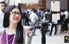  ??  ?? A Xiaomi Corp Mi A1 dual camera device is attached to a tripod to take a photograph during the smartphone's launch in New Delhi, on September 5.