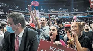  ?? EVAN VUCCI/AP ?? Supporters cheer President Trump on Saturday night at the BOK Center, where upper-level seating was mostly empty.