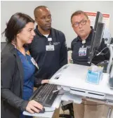  ??  ?? Peer recovery specialist­s at St. Barnabas Medical Center in Livingston, N.J., work with nurse Brenna Zarra to identify a patient referral.