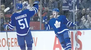  ?? CHRIS YOUNG/THE CANADIAN PRESS ?? Toronto’s William Nylander, right, celebrates with teammate Jake Gardiner after scoring a goal Tuesday against the Winnipeg Jets.