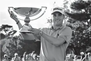  ?? AP Photo/John Amis, File ?? Justin Thomas holds the trophy after winning the Fedex Cup after the Tour Championsh­ip golf tournament Sept. 24 at East Lake Golf Club in Atlanta. The sequel is never easy, and it doesn't help that Thomas had only two days between his PGA Tour player...