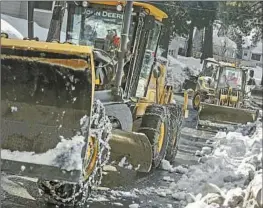  ?? Brian van der Brug Los Angeles Times ?? CALTRANS crews work to clear State Highway 138 in the Valley of Enchantmen­t area of Crestline. Recent storms have left many mountain residents isolated.