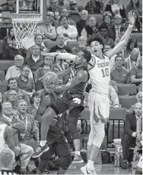  ?? Michael Thomas / Associated Press ?? Senior guard Barry Brown, left, drives past UT’s Jaxson Hayes for two of his 16 points for conference-leading Kansas State.