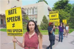  ?? GREG SORBER/JOURNAL ?? Karina Rodgers, left, a University of New Mexico senior and a member of Students for Socialism, joins in a protest Monday against plans by other student groups to bring two conservati­ve speakers to UNM.