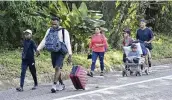  ?? EDGAR H. CLEMENTE / AP ?? Migrants walk along a highway in Huixtla, Mexico, on Monday. A caravan of migrants set out north just before U.S. Secretary of State Antony Blinken arrived in Mexico City to discuss the surge of migrants.