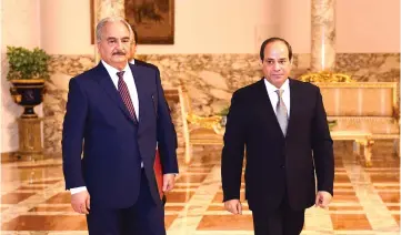  ??  ?? Sisi (right) and Haftar head to their meeting at Ittihadia presidenti­al Palace in Cairo. — AFP photo