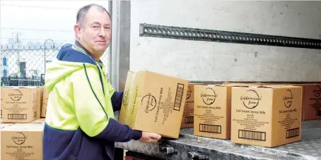  ??  ?? One of Cheffields drivers Greg takes delivery of Caldermead­e Farm milk.