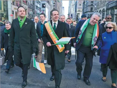  ?? CRAIG RUTTLE / ASSOCIATED PRESS ?? Irish Prime Minister Leo Varadkar (left), New York Democratic Governor Andrew Cuomo (center) and Representa­tive Peter King walk along Fifth Avenue during the St. Patrick’s Day parade on Saturday, in New York.
