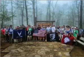  ?? PHOTOS BY SENIOR AIRMAN STEPHANIE SERRANO/USAF ?? Air Force members and their families stationed in Arkansas participat­ed in the 50 Summit Challenge on May 8 at Mount Magazine State Park. Mount Magazine, reaching 2,753 feet, is the tallest mountain in the state of Arkansas.