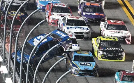  ?? Phelan M. Ebenhack / The Associated Press ?? Kyle Larson (42) hits the wall on the front stretch as Ricky Stenhouse Jr. (17) passes underneath during the NASCAR Cup race in Daytona Beach, Fla.