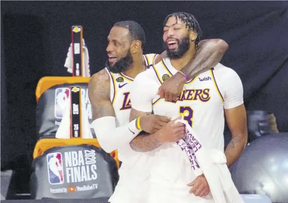  ?? (Photo: AP) ?? Los Angeles Lakers’ Lebron James (23) and Anthony Davis (3) celebrate after the Lakers defeated the Miami Heat 106-93 in game 6 of basketball’s NBA finals Sunday, October 11, 2020, in Lake Buena Vista, Florida.