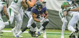  ?? JERRY JACKSON/BALTIMORE SUN ?? Ravens running back Kenyan Drake looks for an opening during the fourth quarter of the season opener against the Jets on Sept. 11. The Ravens running backs have amassed 74 yards on 29 carries (2.6 per attempt) in two games.