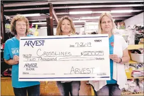  ?? RACHEL DICKERSON/MCDONALD COUNTY PRESS ?? Sue Willmann of Arvest (left) and Shelley Newburn of Arvest (right) present Angie Martin of Crosslines with a check for $2,000.