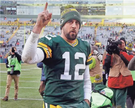  ?? RICK WOOD / MILWAUKEE JOURNAL SENTINEL ?? Packers quarterbac­k Aaron Rodgers acknowledg­es fans after Green Bay’s 38-25 win over the Minnesota Vikings on Saturday at Lambeau Field.