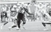  ?? JOHN MCCALL/STAFF WRITER ?? Miami tight end Chris Herndon carries the ball downfield Saturday. He finished with 10 catches for 96 yards.