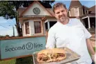  ?? JOE RONDONE ?? Chef Kelly English holds out a roast beef Po’ Boy in front of his restaurant, The Second Line in Overton Square.