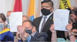  ??  ?? Tribal leaders hold up HB 2772 after signing it in the Steele Auditorium at the Heard Museum in Phoenix on Thursday.