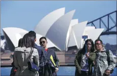  ?? REUTERS ?? Chinese visitors take pictures of themselves as they pose in front of the Sydney Opera House in Sydney. Australia is witnessing a surging Chinese visitor market, according to Tourism Research Australia.