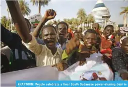  ?? — AFP ?? KHARTOUM: People celebrate a final South Sudanese power-sharing deal in Khartoum.