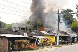  ?? ASSOCIATED PRESS ?? A fire burns Friday after rebels opened fire in a crowded market at Kokrajhar, in the northeaste­rn Indian state of Assam, India.
