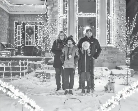  ?? [VERONICA REINER / THE OBSERVER] ?? The Cook family – Ben, Laura, Parker and Paige – have expanded on their Christmas display again this year, with the large collection of lights synchroniz­ed to music. Their Wellesley home has become a popular stop, with drivers able to tune their radios to 100.1 FM to get the full effect.