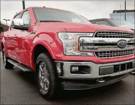  ?? PHOTO BY SCOTT OLSON/GETTY IMAGES ?? Ford F-150 pickup trucks are offered for sale at a dealership on Sept. 6 in Chicago, Ill. Ford loves to point out that an F-Series pickup rolls off the assembly line every 53 seconds or so.