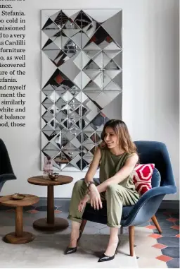  ??  ?? Living area ‘Swoon’ armchairs by Space Copenhagen are paired with a ‘Pon’ side table by Jasper Morrison, both for Fredericia Portrait Homeowner Stefania Aristei sits in front of a 3D-mirrored wall panel made of ‘Mirror Sculptures’ by Verner Panton for Verpan Stockist details on p195 ➤