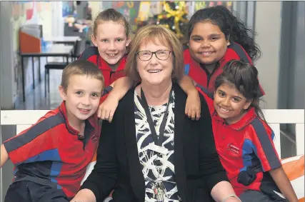  ??  ?? MOVING ON: Horsham Primary School Rasmussen campus assistant principal Brenda Evans shares a moment with students, from left, Jydan Clark, Rebecca-may Williams, Narla Kennedy and Nikita Kennedygol­lan. Picture: PAUL CARRACHER