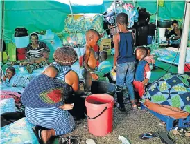  ?? /Jackie Clausen /The Times ?? Resentment: Children gather for bath time in a tented refugee camp for foreign nationals. Plans to set up refugee camps close to borders have come under fire.