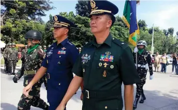  ?? MIRIAM GARCIA DESACADA ?? Lieutenant General Raul Del Rosario (in blue uniform) of the Central Command, guest speaker of 72nd Leyte Gulf Landing anniversar­y, marches with Brigadier General Raul Farnacio, commander of the 8th Infantry Division, during the event ceremony at the...