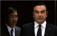  ?? ISSEI KATO / REUTERS ?? Carlos Ghosn (right), chairman and CEO of the Renault-Nissan Alliance and Mitsubishi Motors Chairman and CEO Osamu Masuko attend a news conference in Tokyo on Oct 20.