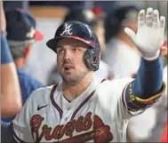  ?? Brett Davis/USA TODAY Sports ?? Atlanta Braves left fielder Adam Duvall (14) celebrates after a two-run home run with teammates against the Oakland Athletics in the seventh inning at Truist Park.