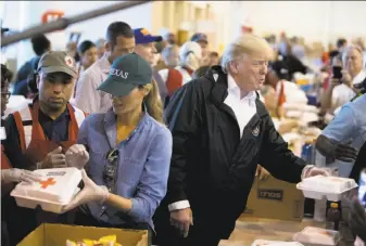  ?? Tom Brenner / New York Times ?? President Trump and first lady Melania Trump pass out meals at the NRG Center in Houston. The convention center is housing hundreds of people displaced by Hurricane Harvey.