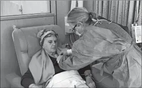  ?? PAUL BLUESTEIN PHOTO VIA AP ?? Lynda Bluestein sits as a nurse organizes tubing during a cancer medicine infusion, Feb. 24, 2023, in Fairfield, Conn.