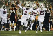  ?? AMANDA LOMAN — THE ASSOCIATED PRESS FILE ?? Stanford’s Curtis Robinson (2), Jonathan McGill (32) and Stephen Herron (15) celebrate Robinson’s recovery of an
Oregon State fumble during the last minute of the second half of a game in Corvallis, Ore. last December. Stanford won 27-24.