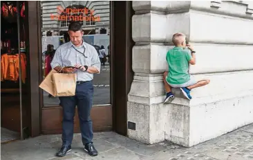  ??  ?? Feeling the heat: A child climbing a wall outside a Superdry clothes store in Regent Street, London. The retailer expects a further hit of about £8mil because a currency hedging strategy did not provide the expected protection. AFP