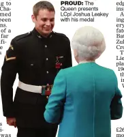  ??  ?? PROUD: The Queen presents LCpl Joshua Leakey with his medal