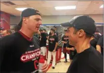  ?? DAVID S. GLASIER — THE NEWS-HERALD ?? Indians outfielder Jay Bruce talks with team president Chris Antonetti during the clinch celebratio­n.