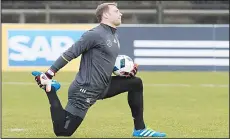  ??  ?? This file photo taken on March 22 shows Germany’s goalkeeper Manuel Neuer
stretching during a training session in Berlin.