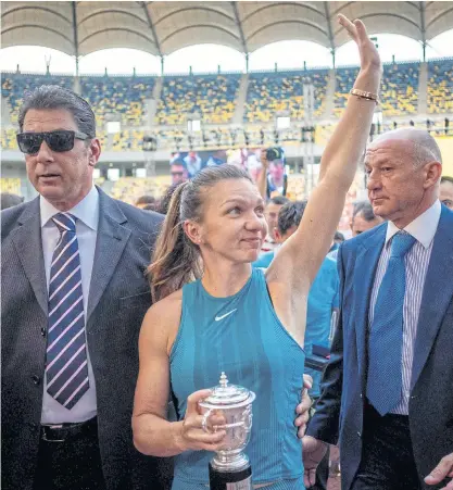  ??  ?? French Open champion Simona Halep waves to fans at the National Stadium in Bucharest.