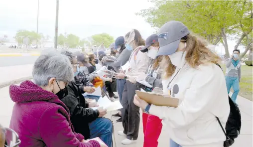  ?? /CARLOS VILLALOBOS ?? Voluntario­s toman datos de los hombres y mujeres que van haciendo fila.