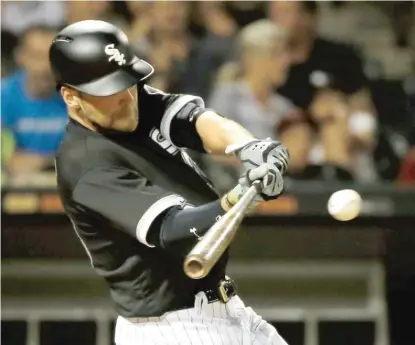  ?? GETTY IMAGES ?? Kevan Smith smacks an RBI single that scored Jose Abreu in the sixth inning Wednesday night at Guaranteed Rate Field.