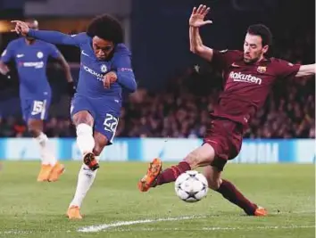  ?? Reuters ?? Chelsea’s Willian scores their first goal against Barcelona in the Champions League round of 16 first Leg just, having also hit the woodwork twice before half-time. The match ended 1-1.