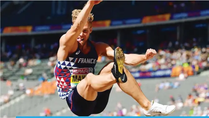  ??  ?? BERLIN: France’s Kevin Mayer competes in the men’s decathlon long jump event during the European Athletics Championsh­ips at the Olympic stadium in Berlin yesterday. —AFP