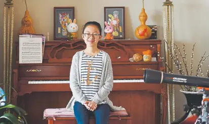  ?? Photos by RJ Sangosti, The Denver Post ?? Lauren Guo, a 13-year-old eighth-grader at Wayne Carle Middle School, is one of Colorado’s 15 qualifiers bound for the 92nd Scripps National Spelling Bee. It starts Monday in National Harbor, Md., near Washington.
