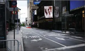  ?? (Getty Images/TNS/Spencer Platt) ?? Broadway theaters stand closed along an empty street in the theater district on June 30 in New York. At the one-year anniversar­y of the fateful day, with the pandemic raging but in retreat, hopes for the industry’s return have crept up on the horizon.